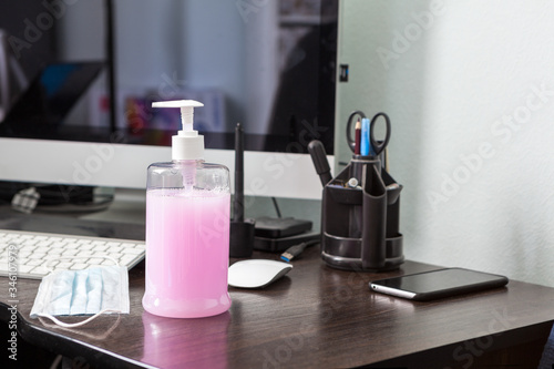 Liguid alcohol sanitizer standing on working desk  gel for hands antibacterial cleaning and hygiene from virus  nobody