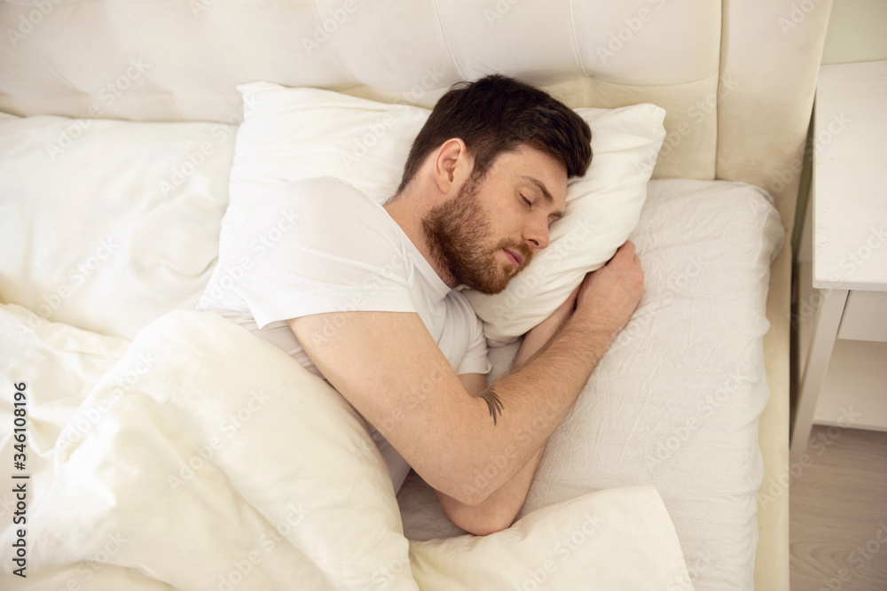 Handsome Man Sleeping Cozily in Bed at Home. Sweet Dreaming. Up Down View Handsome Man Sleeping Cozily in Bed at Home. Sweet Dreaming. Up Down View