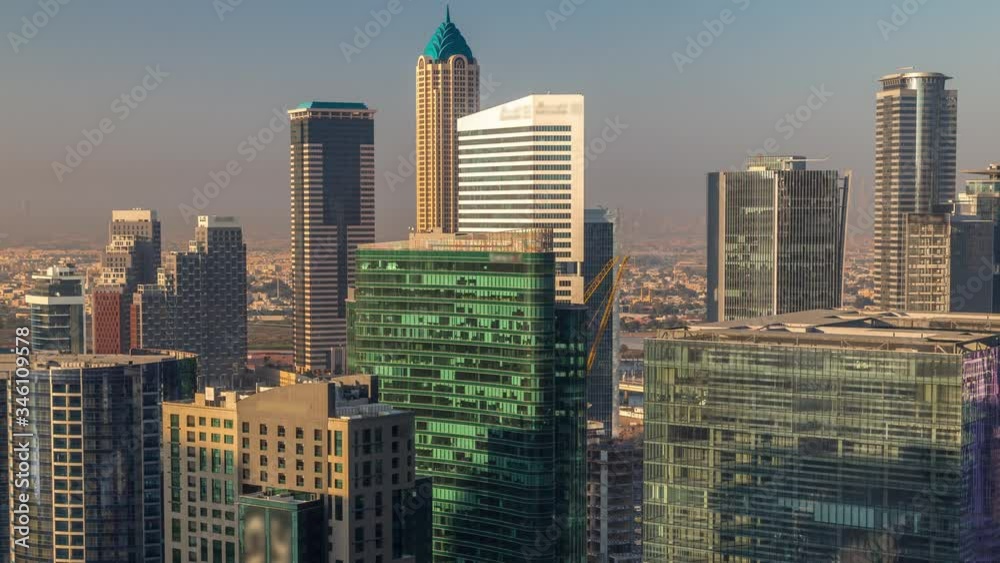 Dubai's business bay towers at morning aerial timelapse. Rooftop view of some skyscrapers and new towers under construction. Hazy weather with shadows mooving fast Dubai's business bay towers at morning aerial timelapse. Rooftop view of some skyscrapers and new towers under construction. Hazy weather with shadows mooving fast