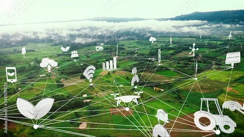 Aerial view, smart farming icon with network  on Green farm fields near the mountains