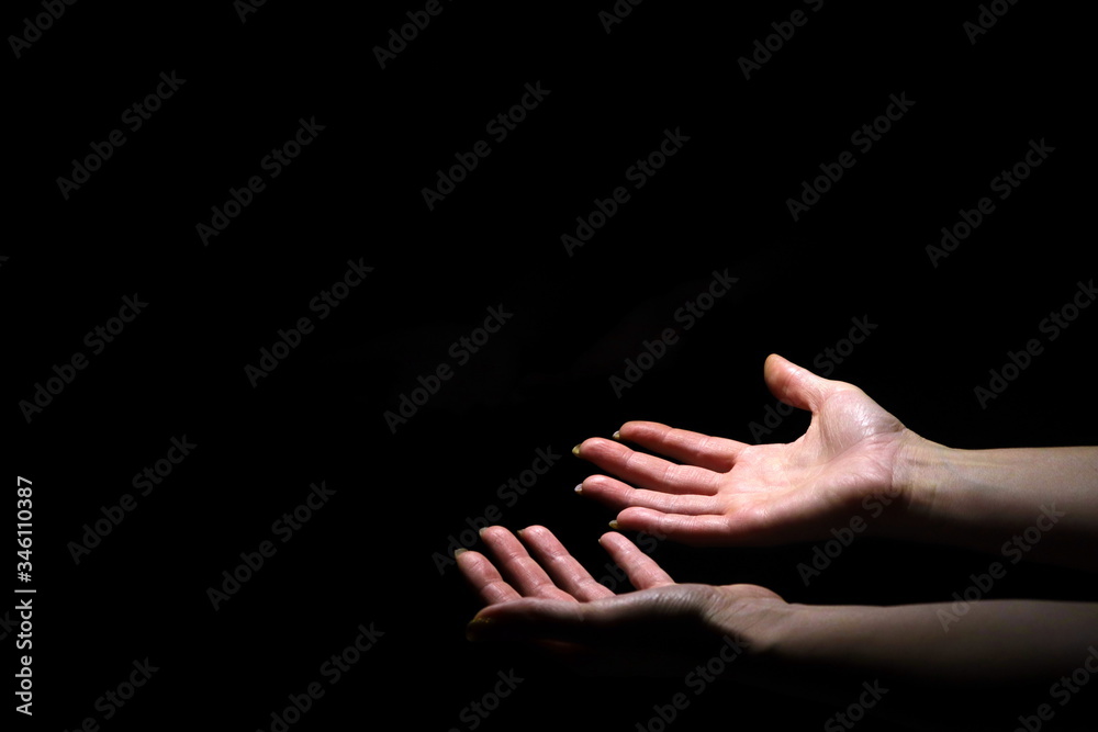 Fototapeta premium two hands on a black background 1