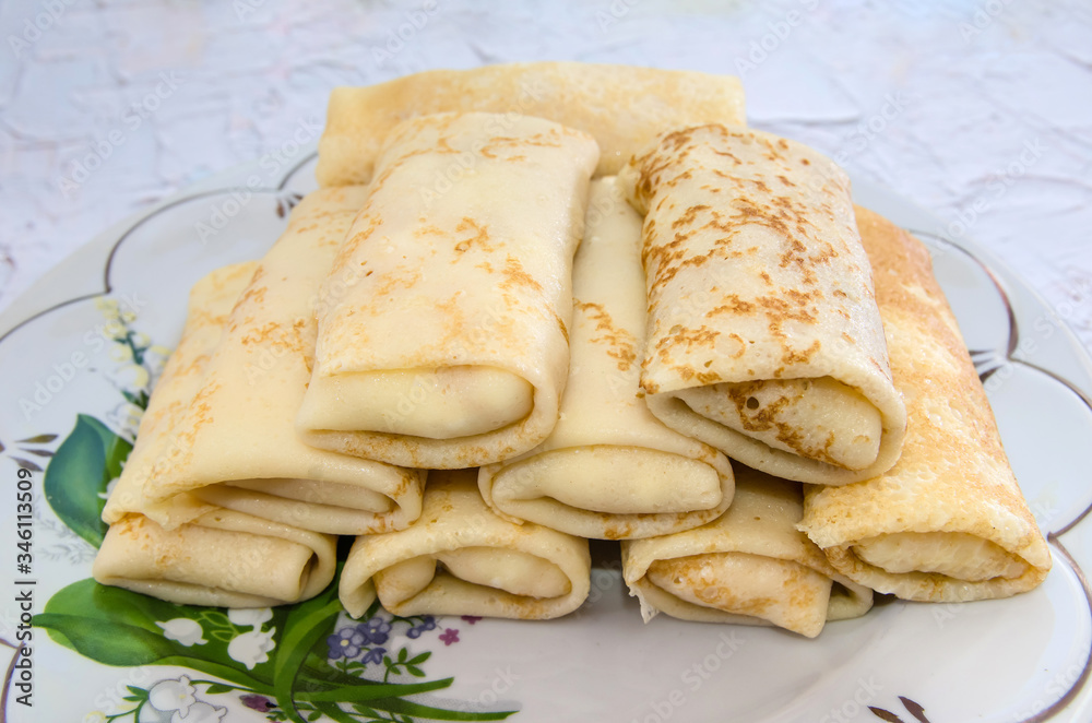 rolled pancakes in a plate, close-up rolled pancakes in a plate, close-up