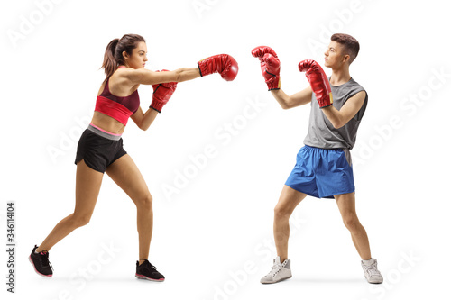Young girl and guy in sportswear fighting with boxing gloves © Ljupco Smokovski