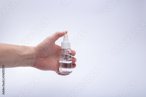 hand and bottle of antiseptic protection against the virus