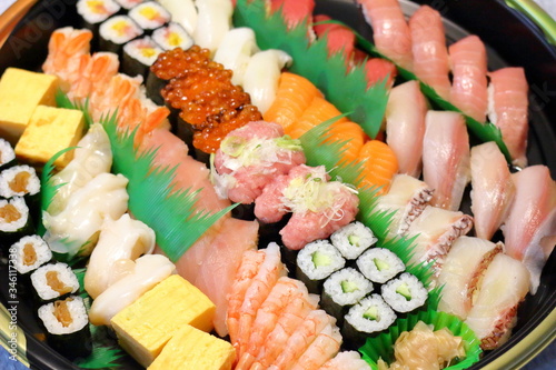 Overhead view of Japanese food sushi . several rolls with tuna, salmon and shrimp. Japanese delivery sushi set at home party.