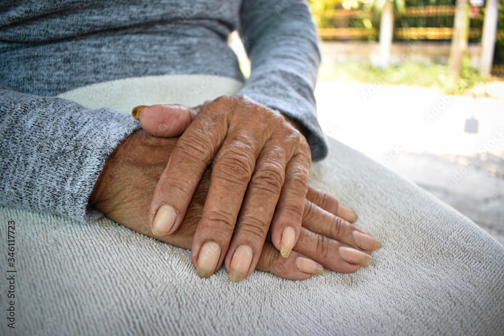 Fototapeta premium Hand of an old woman withering on his lap