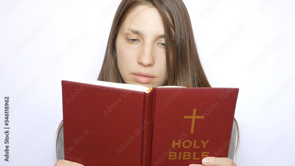 A young beautiful woman reads the Holy Bible A young beautiful woman reads the Holy Bible