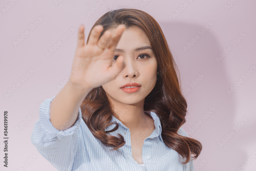 Portrait of a beautiful blond girl covering face by hand of bright sun light Portrait of a beautiful blond girl covering face by hand of bright sun light
