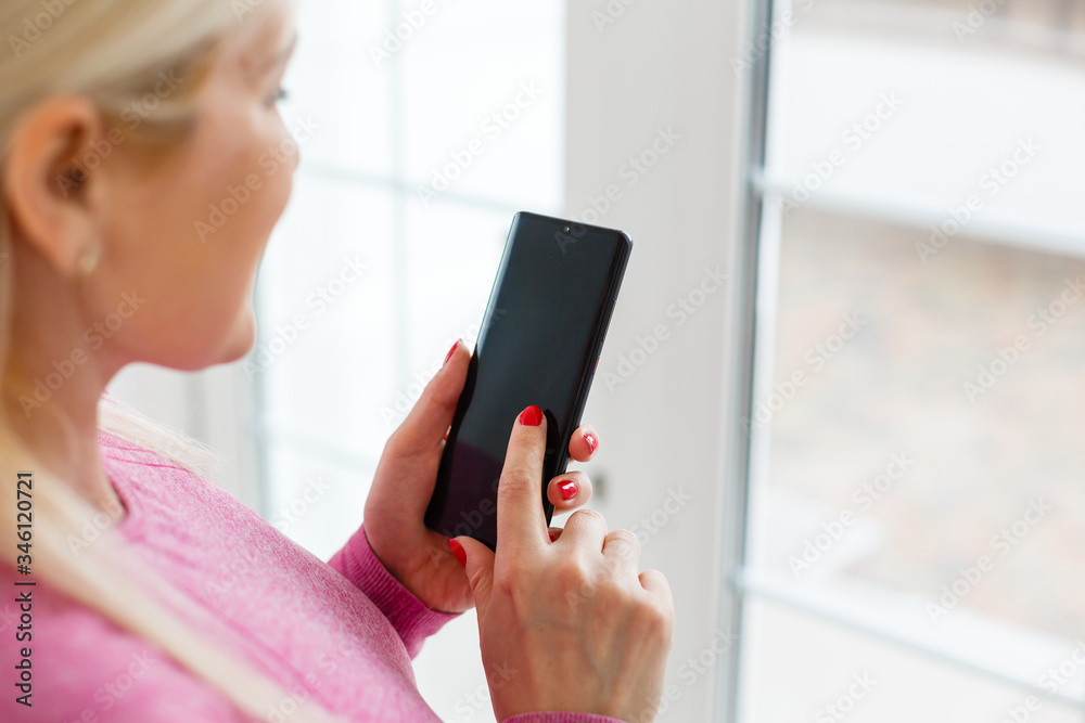 female hands holding white phone with isolated screen and e-rider on the women table female hands holding white phone with isolated screen and e-rider on the women table
