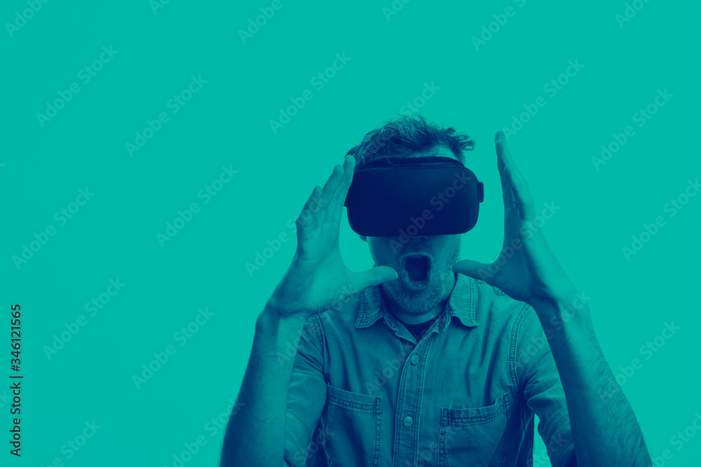Man in his 30's wearing a VR virtual reality headset. Graphic duotone style Man in his 30's wearing a VR virtual reality headset. Graphic duotone style