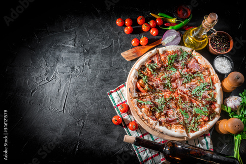 Traditional Italian pizza, vegetables, ingredients for cooking on dark background. Pizza menu