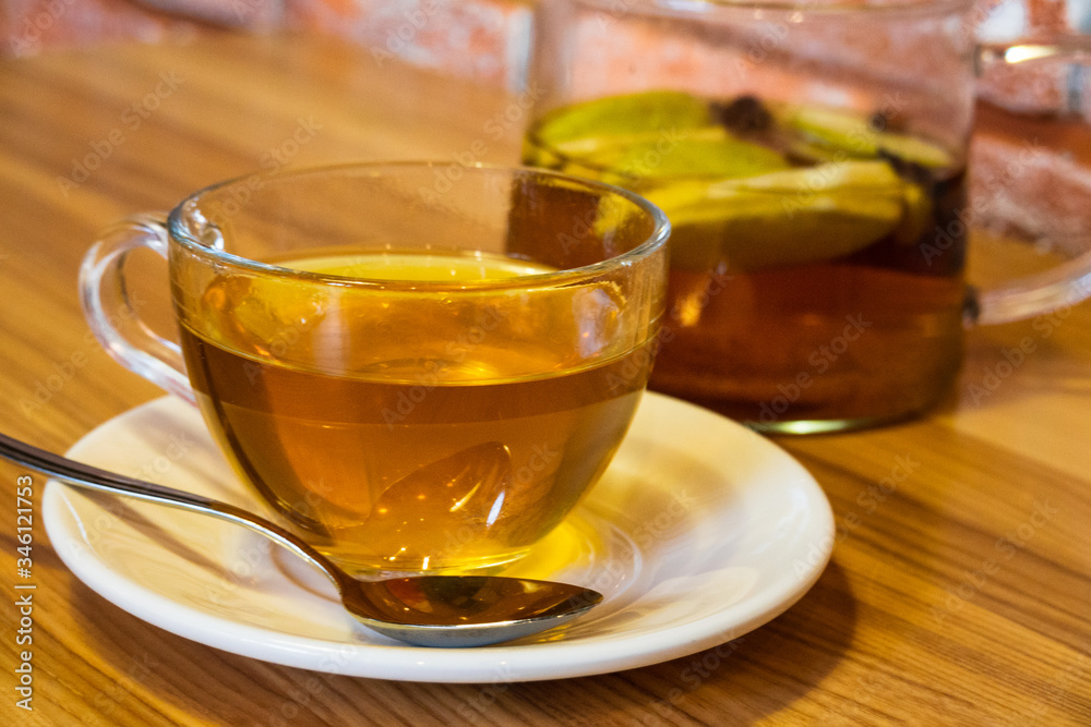 Cup and teapot filled with herbal tea Cup and teapot filled with herbal tea