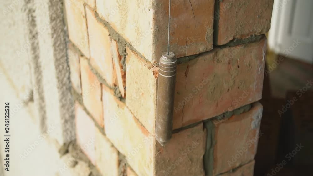 builder measures the evenness of the wall builder measures the evenness of the wall