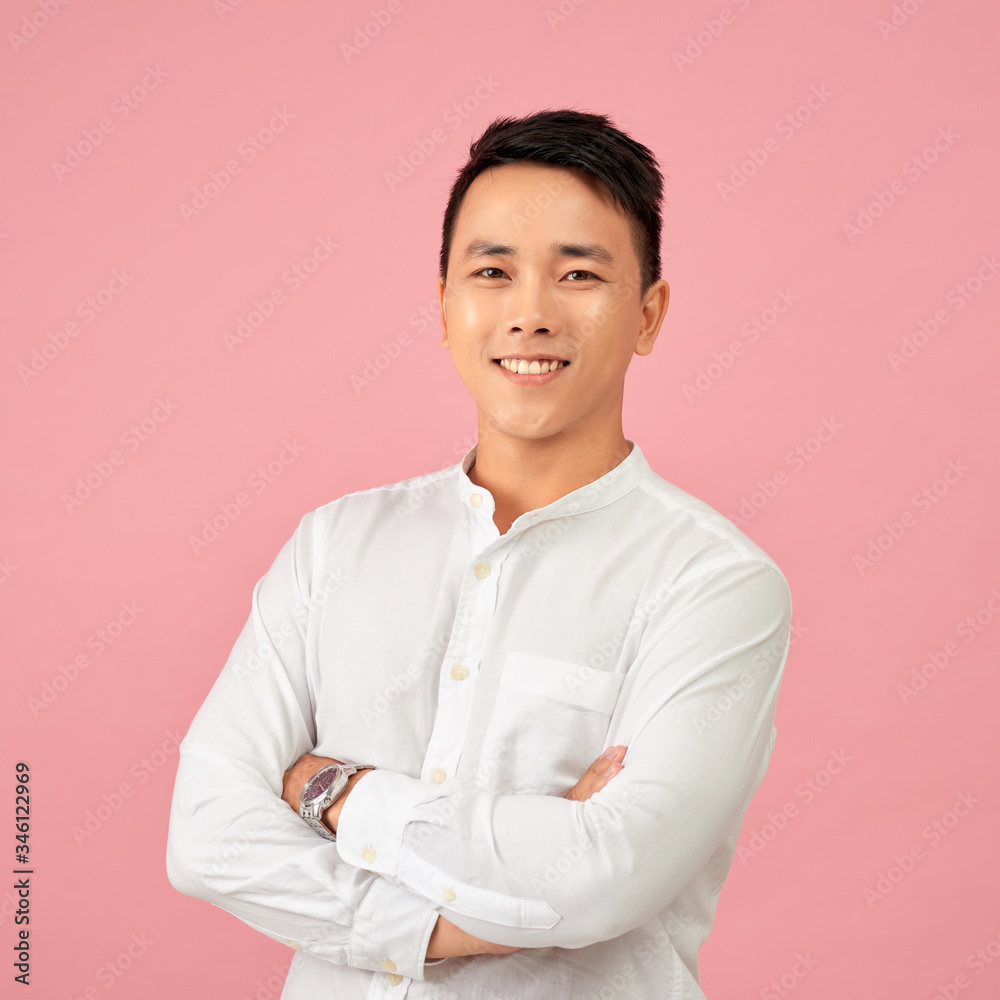 Young Asian male smiling and laughing with arms crossed Young Asian male smiling and laughing with arms crossed
