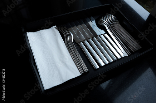 Place Setting with Knife, spoon and Fork with tissue paper is in the black tray.