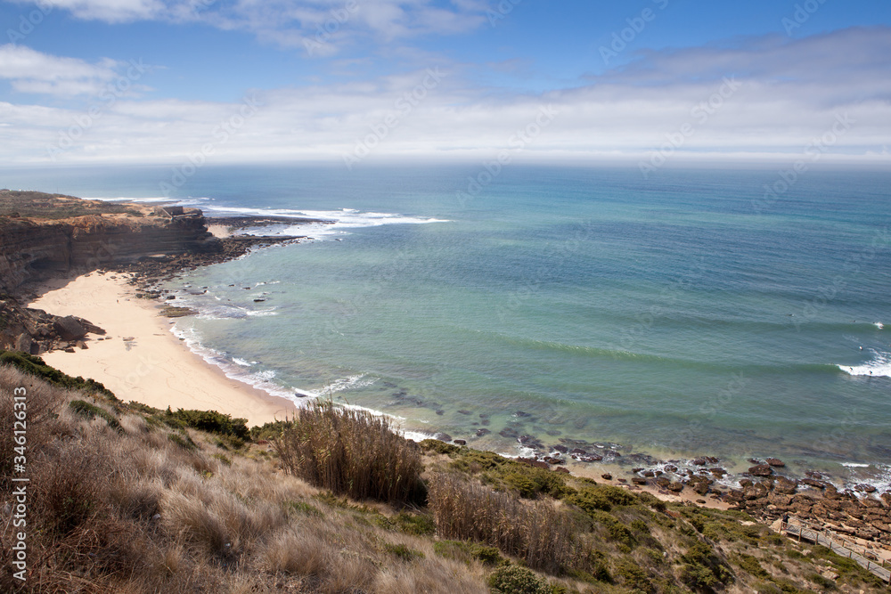 Stunning views of the north beach at the Ericeira World Surf Reserve with surfers in the ocean, Portugal