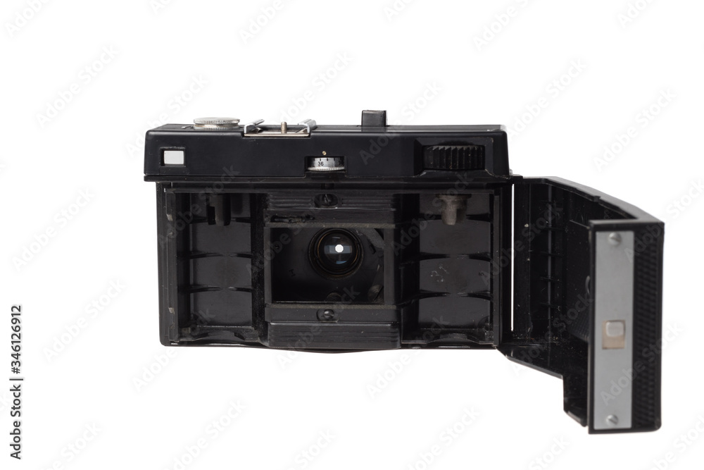 Vintage photo camera using film strip with open back showing open aperture, isolated on white background