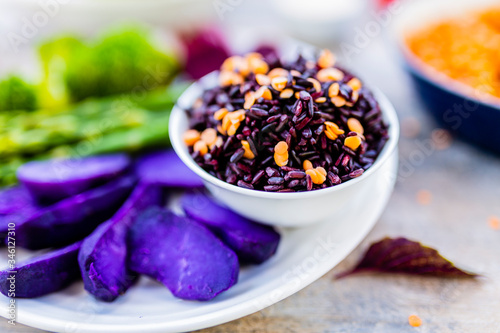 Black rice with red lentils and colorful vegetables.  Healthy and vegetarian food.  photo