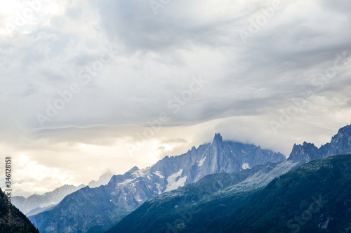 Fototapeta Naklejka Na Ścianę i Meble -  French Alps mountains in a cloudy summer day, seen from Les Houches near Chamonix, Haute Savoy, France.