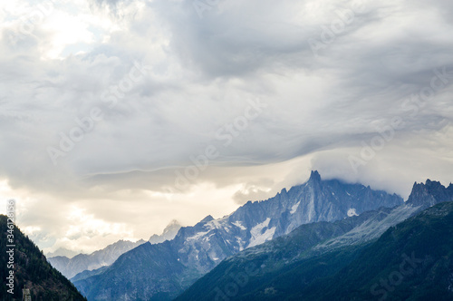 Fototapeta Naklejka Na Ścianę i Meble -  French Alps mountains in a cloudy summer day, seen from Les Houches near Chamonix, Haute Savoy, France.