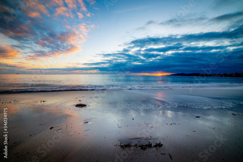 Dark clouds over the sea at sunset in Maria Pia beach in Alghero