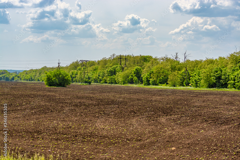 Plowed field in spring time with blue sky.