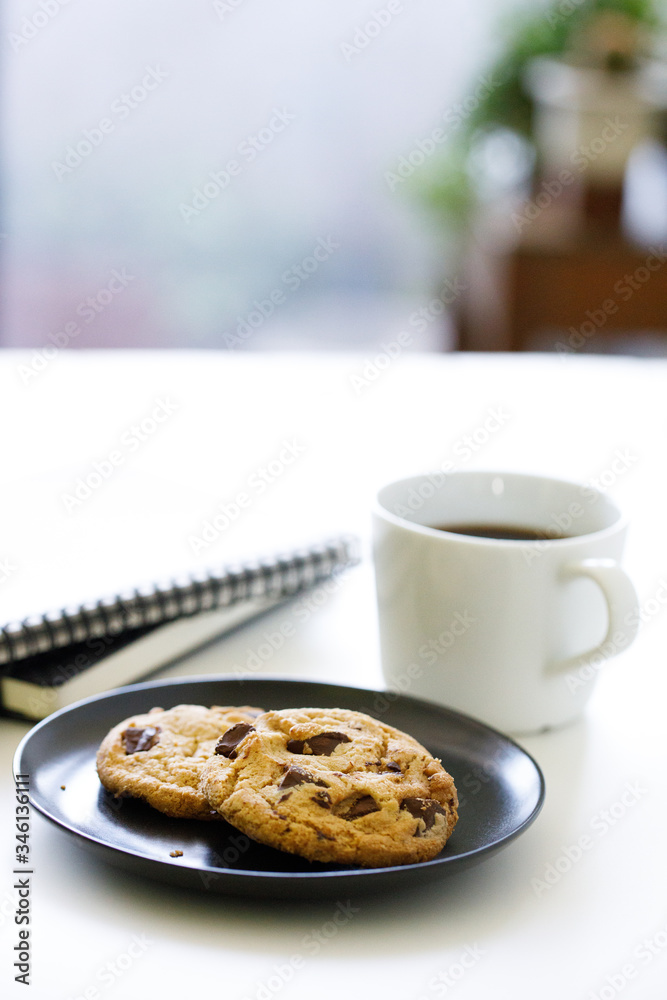 cup of hot black coffee on white table background with notebook and stationery. Work from home concept. cup of hot black coffee on white table background with notebook and stationery. Work from home concept.