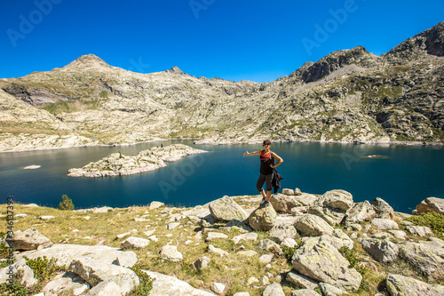 A young woman in the Bachimaña de Panticosa Reservoir in the Pyrenees, Aragon. Spain