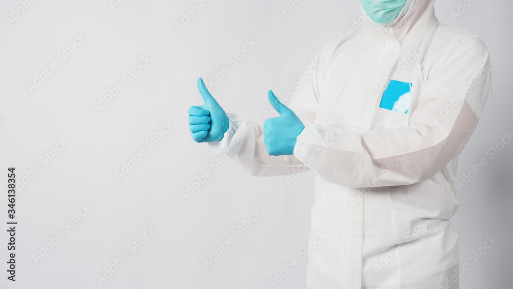 male model in PPE suite doing goodluck hand sign on white background. male model in PPE suite doing goodluck hand sign on white background.