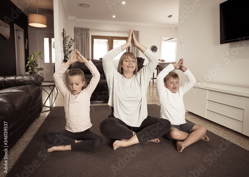 COVID-19 Outrbreak. Family doing yoga together at home during coronavirus quarantine