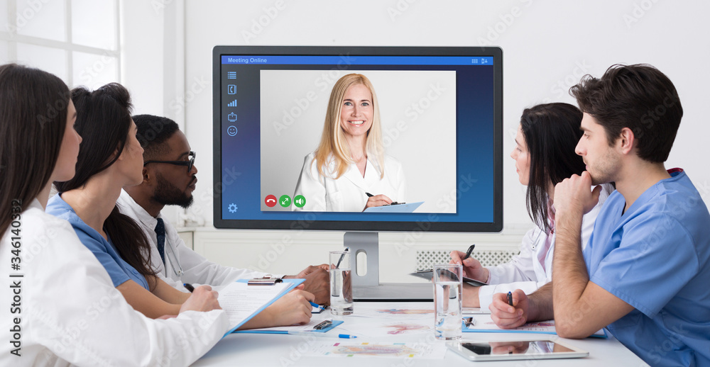 Telemedicine concept. Group of young doctors having online conference in hospital, collage Telemedicine concept. Group of young doctors having online conference in hospital, collage