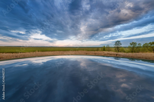 stormy sky reflects off the surface and horizon in the center of the frame