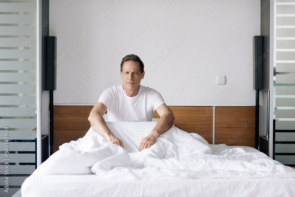 handsome man sitting and looking at camera in morning handsome man sitting and looking at camera in morning
