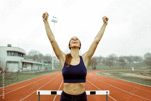 Sportive woman celebrating after winning a runner competition
