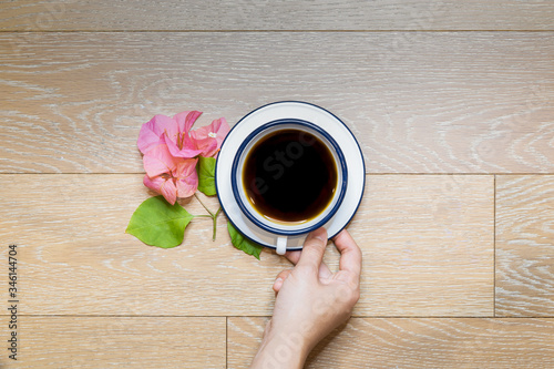 Overhead female hands holding cups of coffee