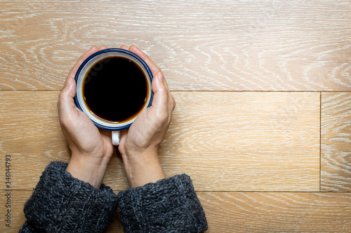 Female hands holding cup of coffee