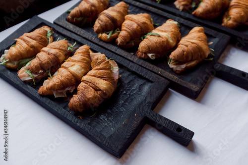 Fresh croissant on wooden table