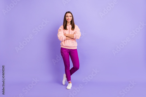 Full length photo of funny pretty lady beaming smiling good mood hold hands crossed ready for walk outside wear casual fur fuzzy sweater pants isolated purple color background