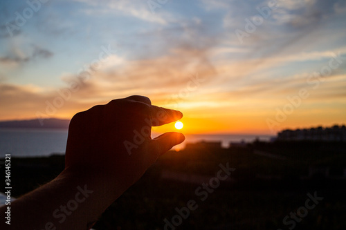 silhouette of hand backlit at sunset view