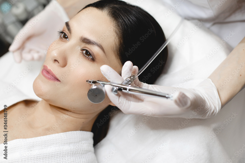 Picture of hand in white glove holding non injection tool for skincare and beauty treatment. Care of wellness and beauty. Beautician's room. Picture of hand in white glove holding non injection tool for skincare and beauty treatment. Care of wellness and beauty. Beautician's room.