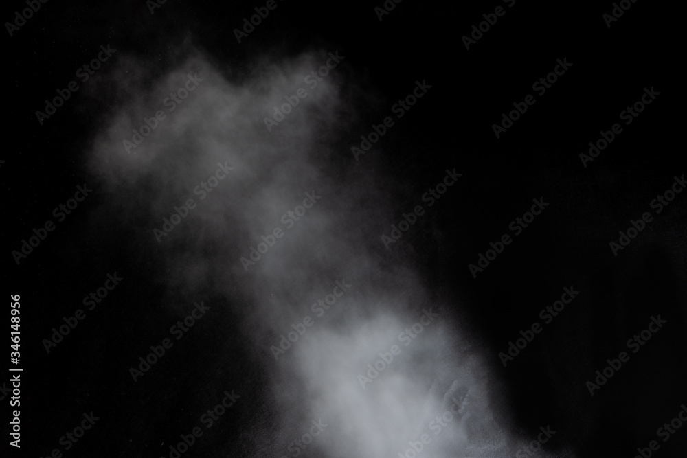 White clouds of smoke vapor isolated on a black background. Gas explodes, whirls and dances in space White clouds of smoke vapor isolated on a black background. Gas explodes, whirls and dances in space