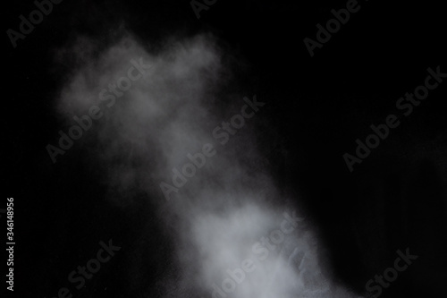 White clouds of smoke vapor isolated on a black background. Gas explodes, whirls and dances in space
