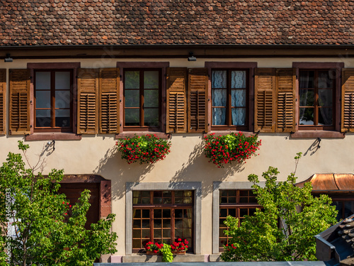 Fototapeta Naklejka Na Ścianę i Meble -  Flowering village in Alsace. Sunlit streets full of flowers.