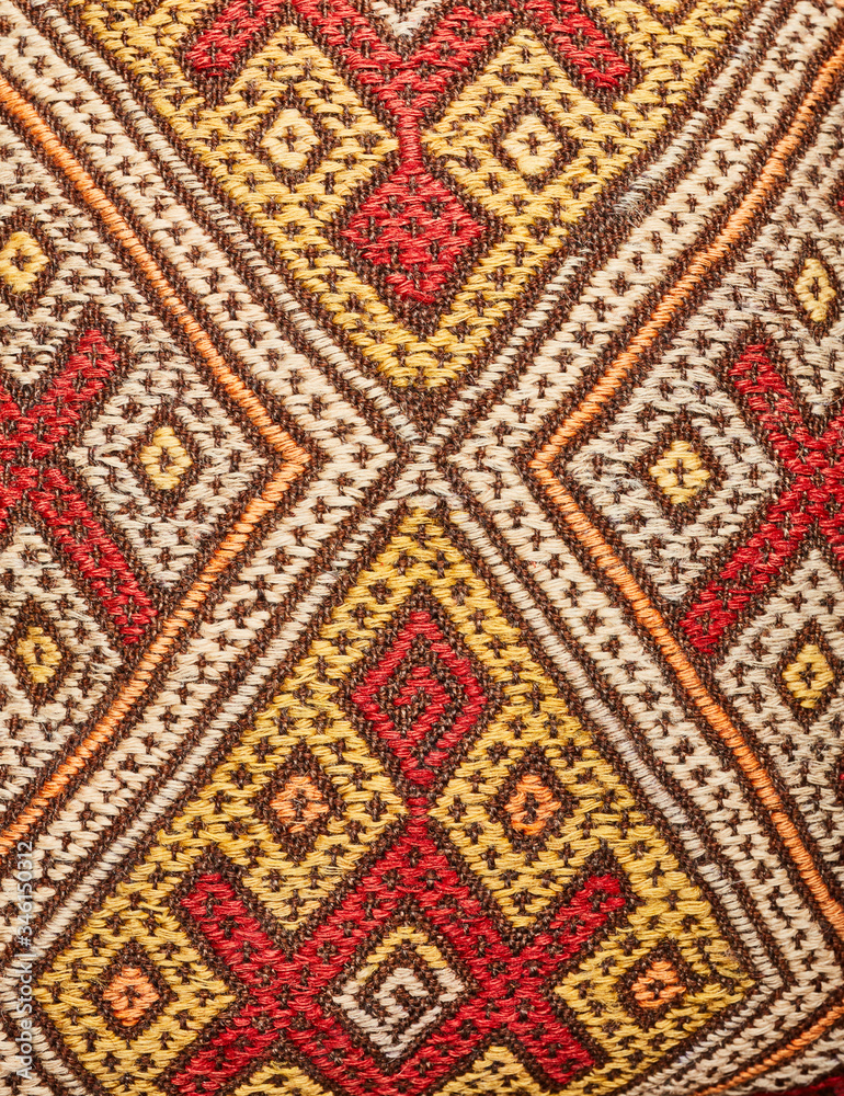 fragment of an old woolen carpet with an ornament