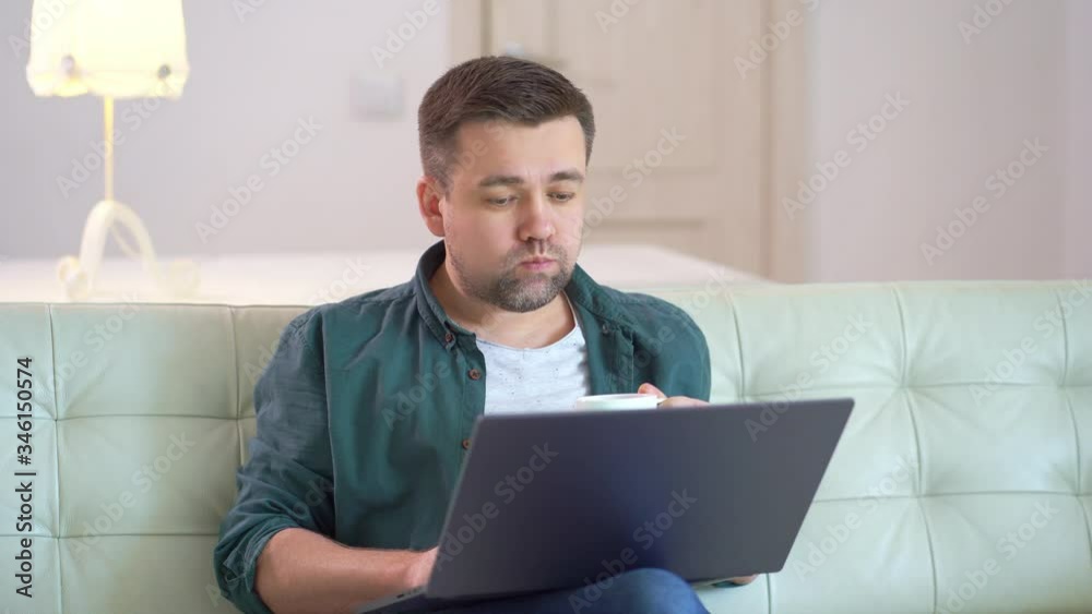 freelancer working at a computer and drinking tea freelancer working at a computer and drinking tea