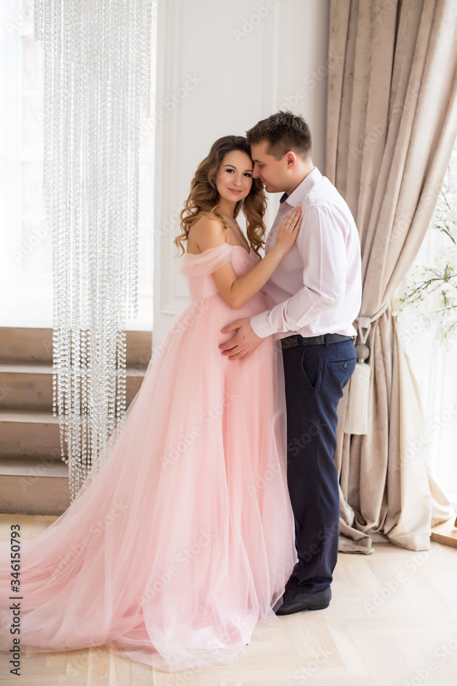 Beautiful pregnant women with man at pink dress Beautiful pregnant women with man at pink dress