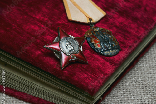 Combat and labor awards of the Second World War in the USSR. Old wartime photo album with soft red cover. Victory Day May 9th. photo