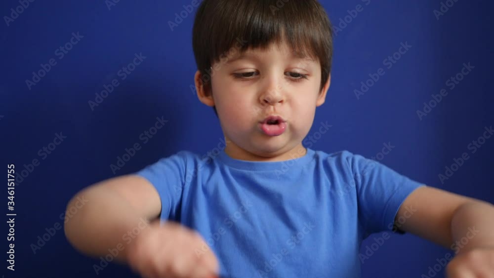 child sits at home on a sofa in a blue T-shirt plays at home during self-isolation in colored pencils child sits at home on a sofa in a blue T-shirt plays at home during self-isolation in colored pencils