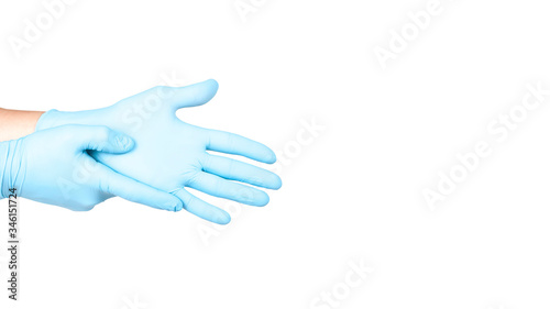 Hands of a medic in the blue latex gloves on white background. Copy space