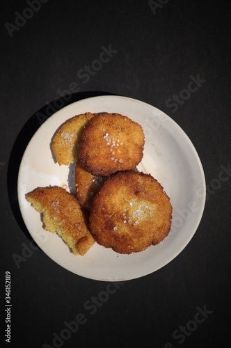 Homemade Semolina Cookies with Sugar in a Plate Isolated on Black Background in Vertical Orientation